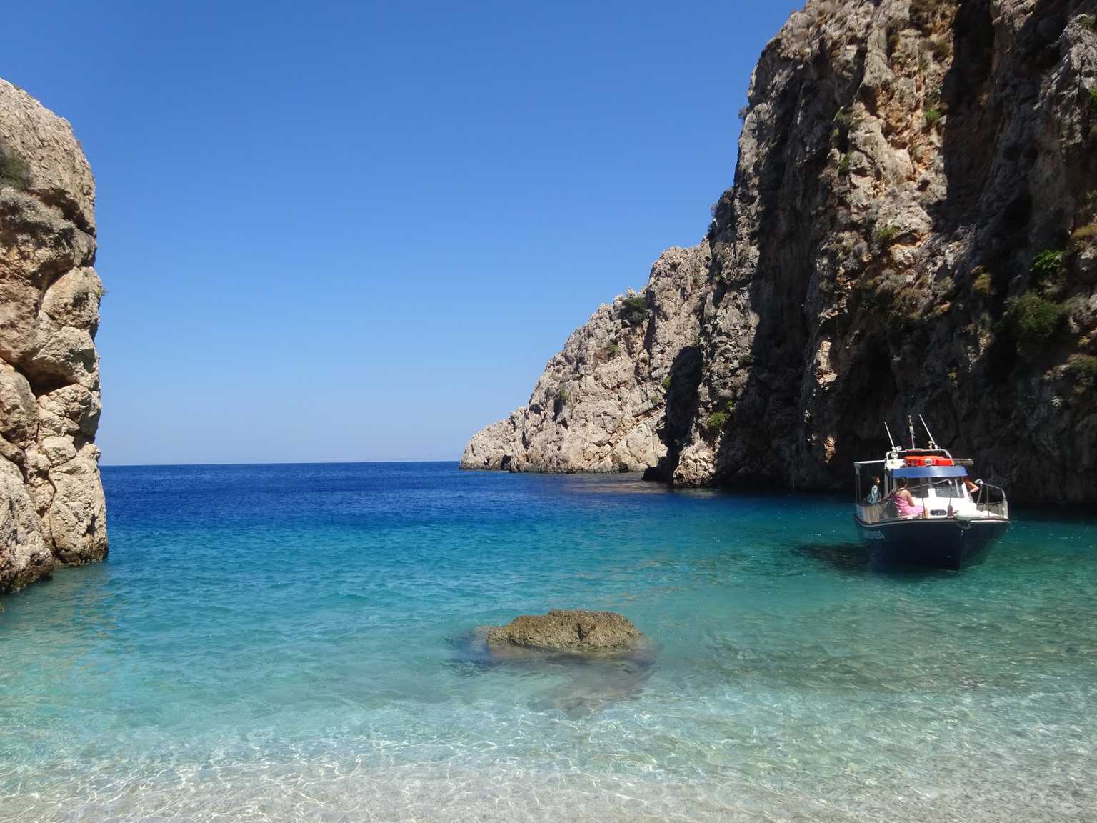 chalki areta beach view with boat